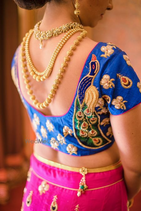 Photo of Blue blouse with peacock embroidery and back jewellery