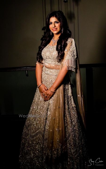 Photo of Bride wearing a fully embellished olive green lehenga