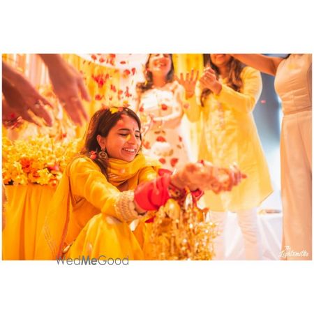 Photo of A bride caught in a happy moment on Haldi ceremony.