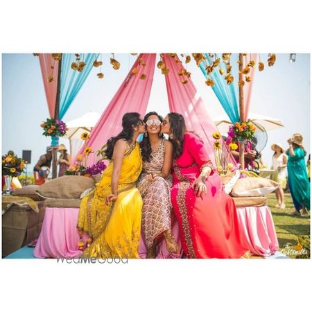 Photo of Bride with her bridesmaid on mehndi ceremony.