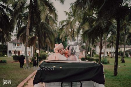 Photo of couple kissing in exit car portrait