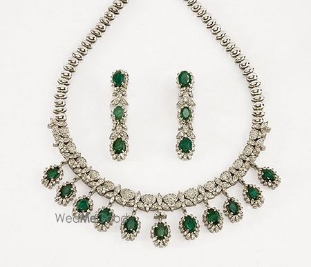 Photo of diamond and embellished green necklace and earrings