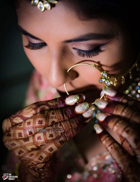 Photo of Bride getting ready shot adjusting nosering