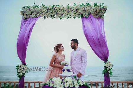 Photo of Couple portrait in destination wedding with purple drape backrop