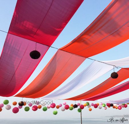 Photo of outdoor red pink and white drapes