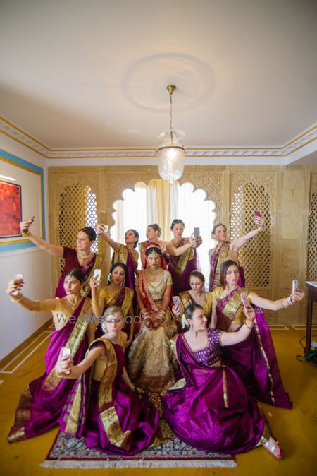 Photo of Cute photo with bride and matching bridesmaids taking selfies