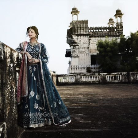 Photo of Blue and silver lehenga with double dupatta, contrasting pink banarasi dupatta.