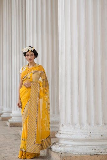 Photo of bright canary yellow saree with short sleeved blouse and big border