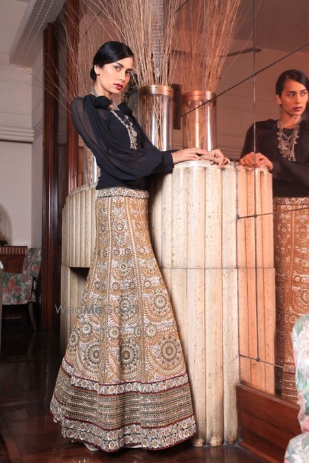 Photo of navy blue full sleeves with gold embellished lehenga