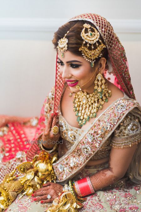 Photo of Bridal pose with heavy bridal jewellery and beautiful jhoomer