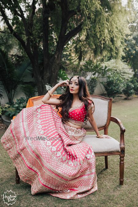 Photo of Bride posing in bright pink gota patti lehenga