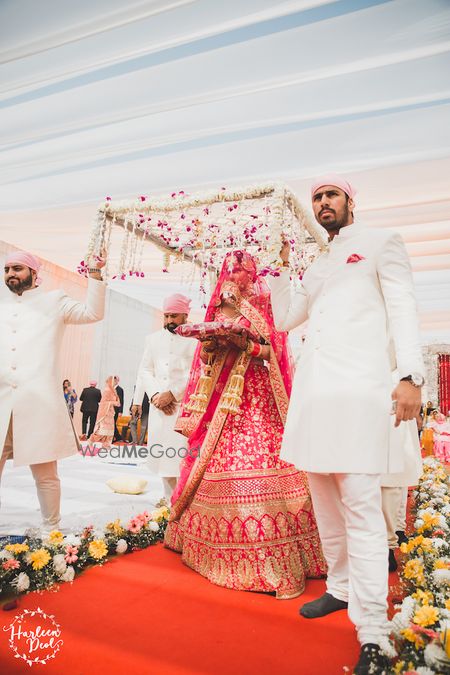 Photo of Bride entering with veil and matching brides men