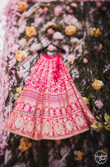 Photo of Red lehengas with gold motifs Sabyasachi on hanger