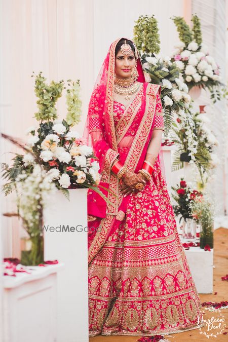 Photo of Red and gold Sabyasachi bridal lehenga on bride