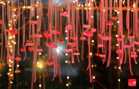 Photo of Hanging strings with pink and red pompoms