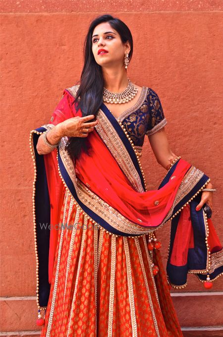 Photo of red and blue banarsi print lehenga