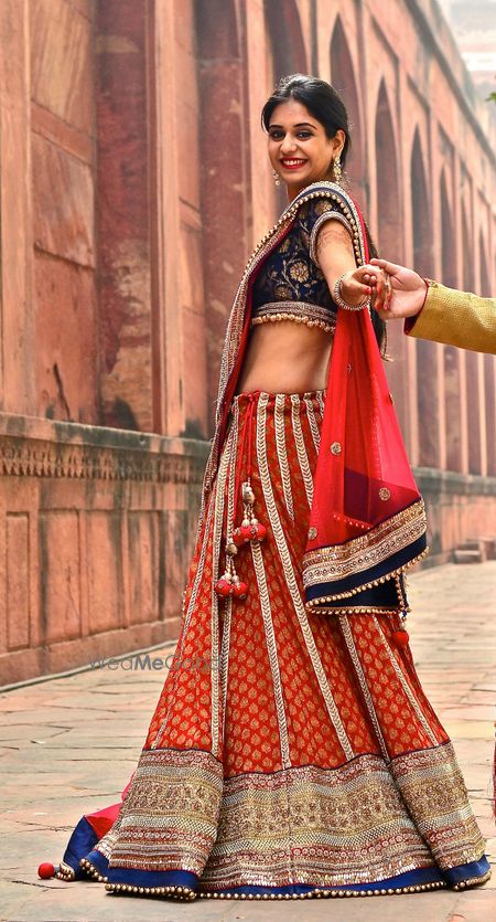 Photo of red and blue banarsi print lehenga