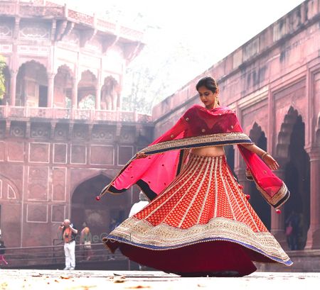 Photo of red and blue banarsi print lehenga