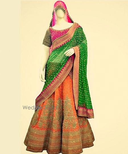 Photo of orange and green bridal lehenga