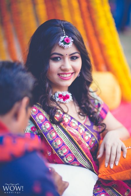 Photo of Bride wearing floral choker on mehendi