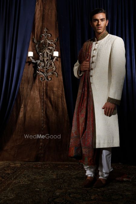 Photo of white and gold sherwani