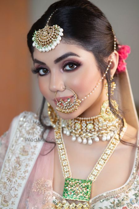 Photo of A bride in a white lehenga and subtle makeup for her wedding