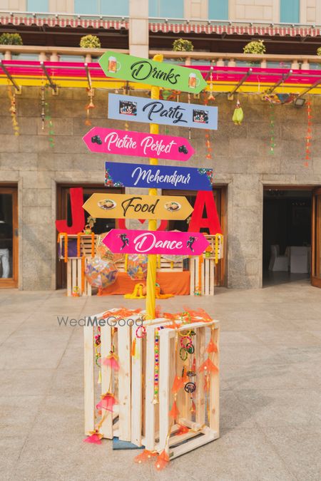 Photo of Cute mehendi decor idea with direction boards