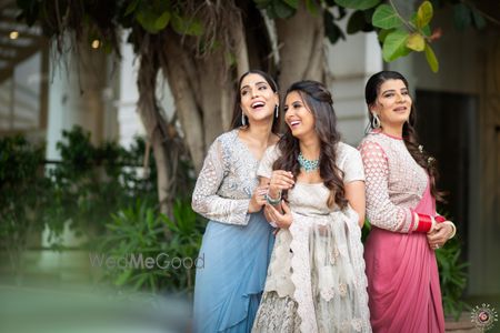 Photo of happy bride and bridesmaid shot outdoors