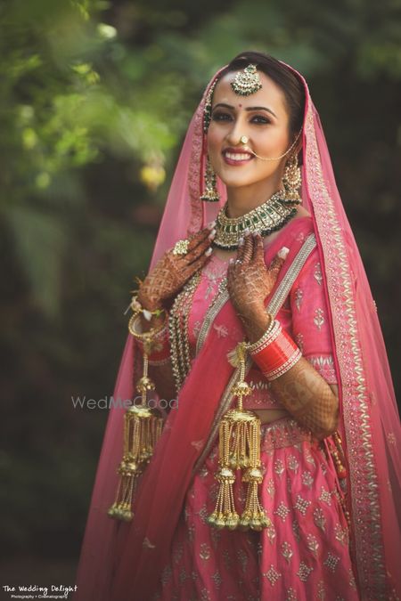 Photo of Sikh bride in bright pink bridal lehenga and kaleere