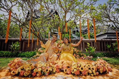 Photo of Lovely outdoor haldi in orange and yellow themed looks