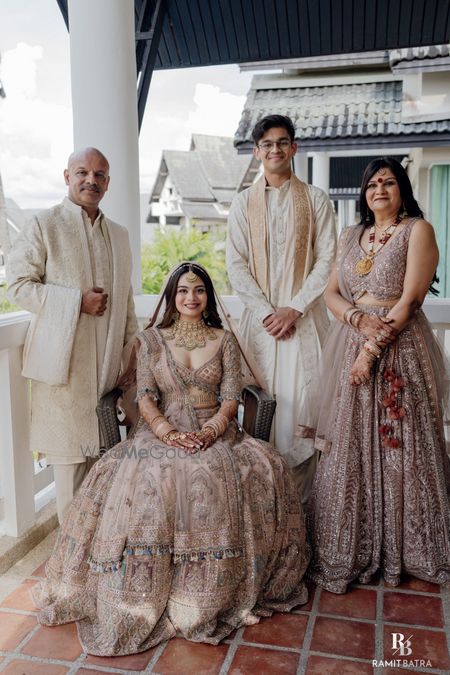 Photo of Classic family portrait of the bride and her family, all in pastels on the wedding day