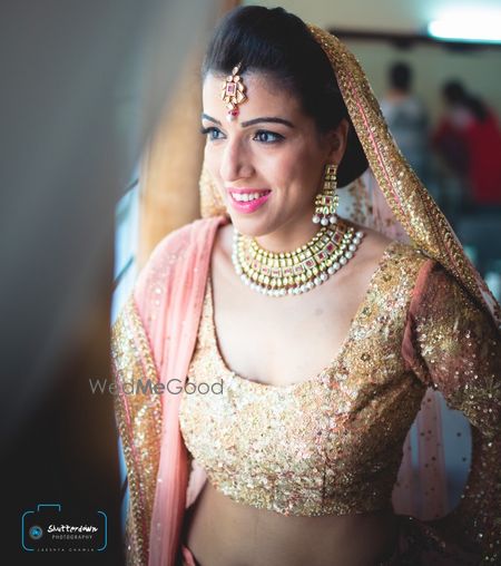 Photo of peach and gold lehenga