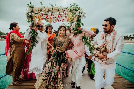 Photo of bridal entry shot in offbeat Sabyasachi lehenga