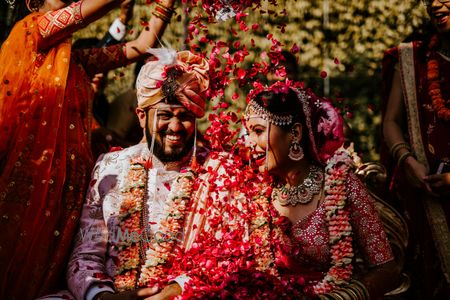 Photo of rose petal shower on couple