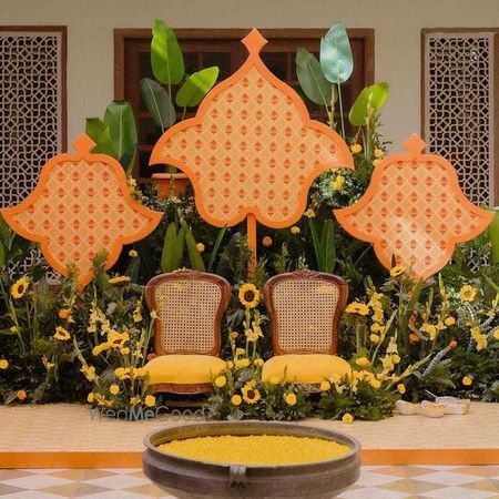 Photo of colorful yellow and orange haldi decor