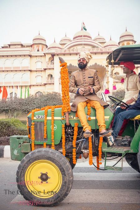 Photo of Groom entering sitting on a tractor