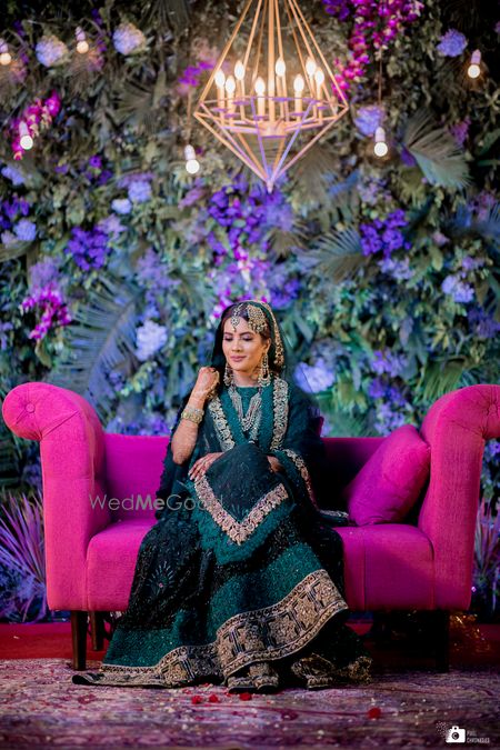 Photo of A lovely bride in a stunning teal coloured sharara and gold jewellery.