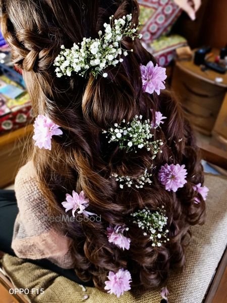 Photo of Half up half down hairstyle with baby's breaths and lavender flowers.