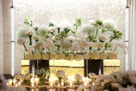 Photo of White and green floral installation at reception