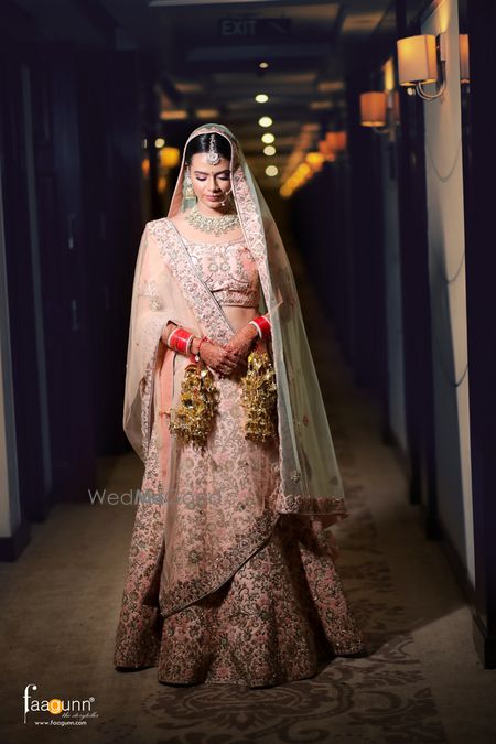 Photo of Bridal portrait in light pink lehenga and contrasting pastel dupatta