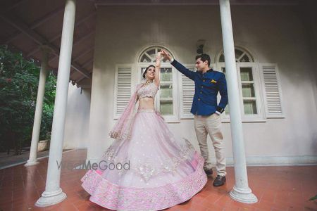 Photo of Couple Dancing with Twirling Bride Shot