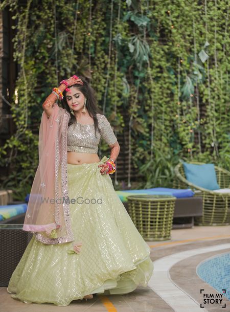 Photo of pastel green and pink mehendi lehenga for bride