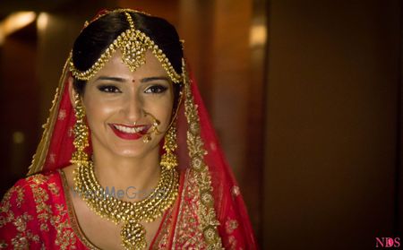 Photo of Bride in Gold Polki Jewellery with Pink Lehenga