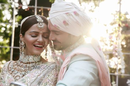 Photo of A bride and groom in coordinated outfits