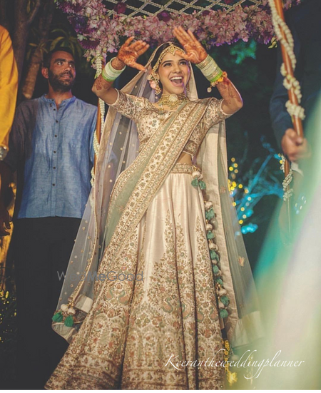 Photo of happy dancing bride entering shot on wedding