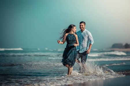 Photo of fun and playful pre wedding shot on the beach