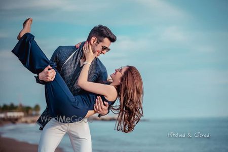 Photo of romantic honeymoon shoot idea with groom picking bride