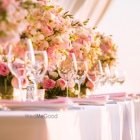 Photo of Table settings done with pastel hued flowers