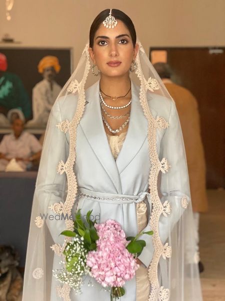 Photo of Millennial bride in a pantsuit with a dupatta as a veil