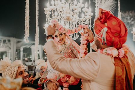 Photo of happy couple during the jaimala shot